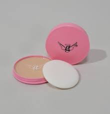 Polvo compacto de color rosa con borla, abierto, sobre fondo gris.