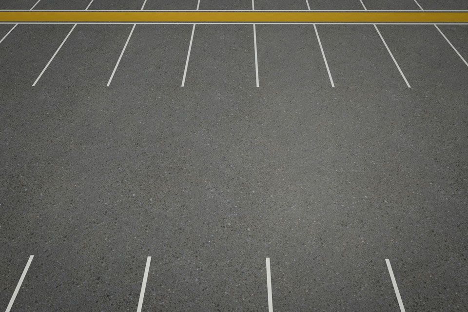 An Empty Parking Lot With White Lines and a Yellow Line | Round Lake, IL | Korinek & Son Concrete and Asphalt