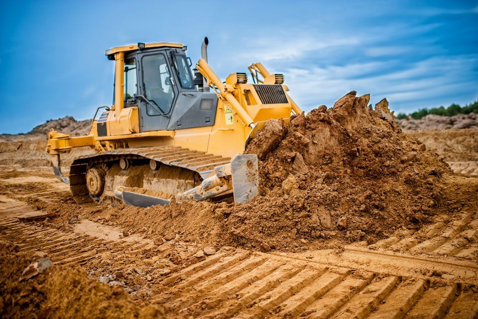 A Bulldozer is Moving Dirt on a Construction Site | Round Lake, IL | Korinek & Son Concrete and Asphalt