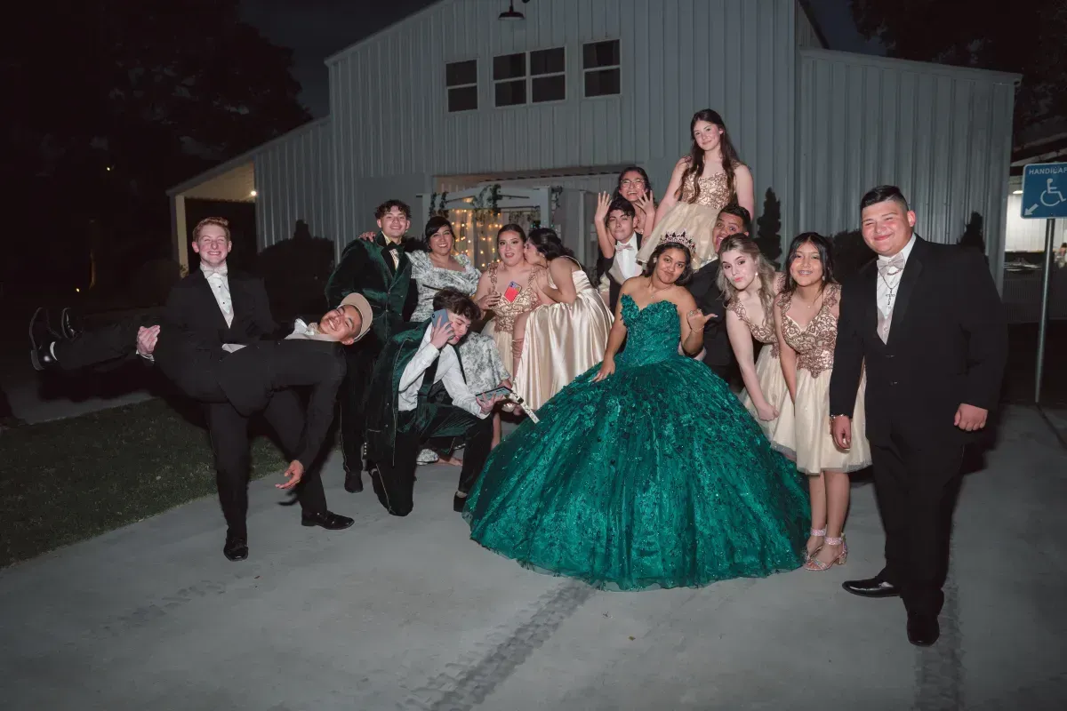 A group of people are posing for a picture in front of a building.