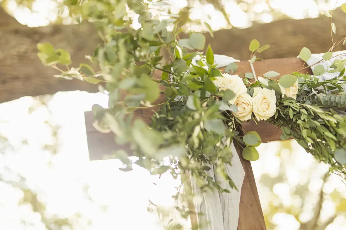 A person is holding a wreath of flowers in their hands.