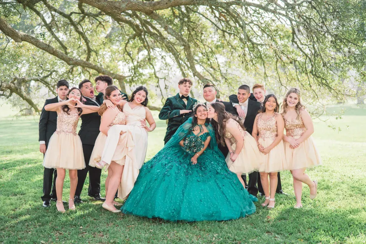 A group of people are posing for a picture under a tree.