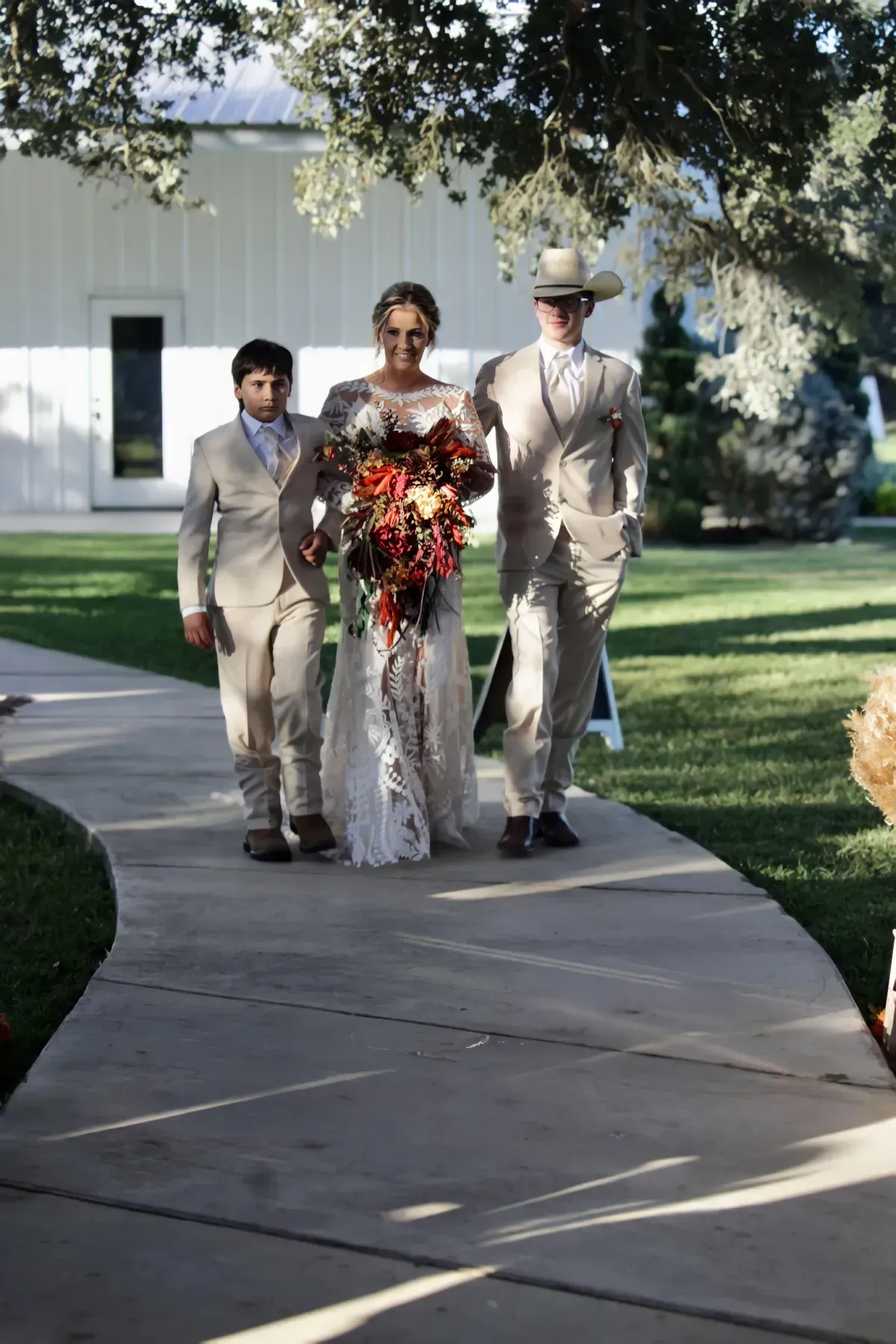 A bride and groom are walking down the aisle at their wedding.