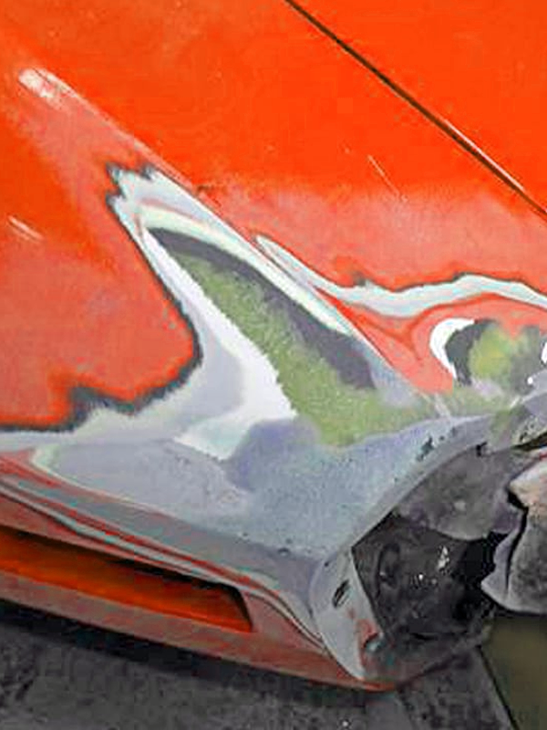 Fiberglass car body panel repair in progress on an orange car.