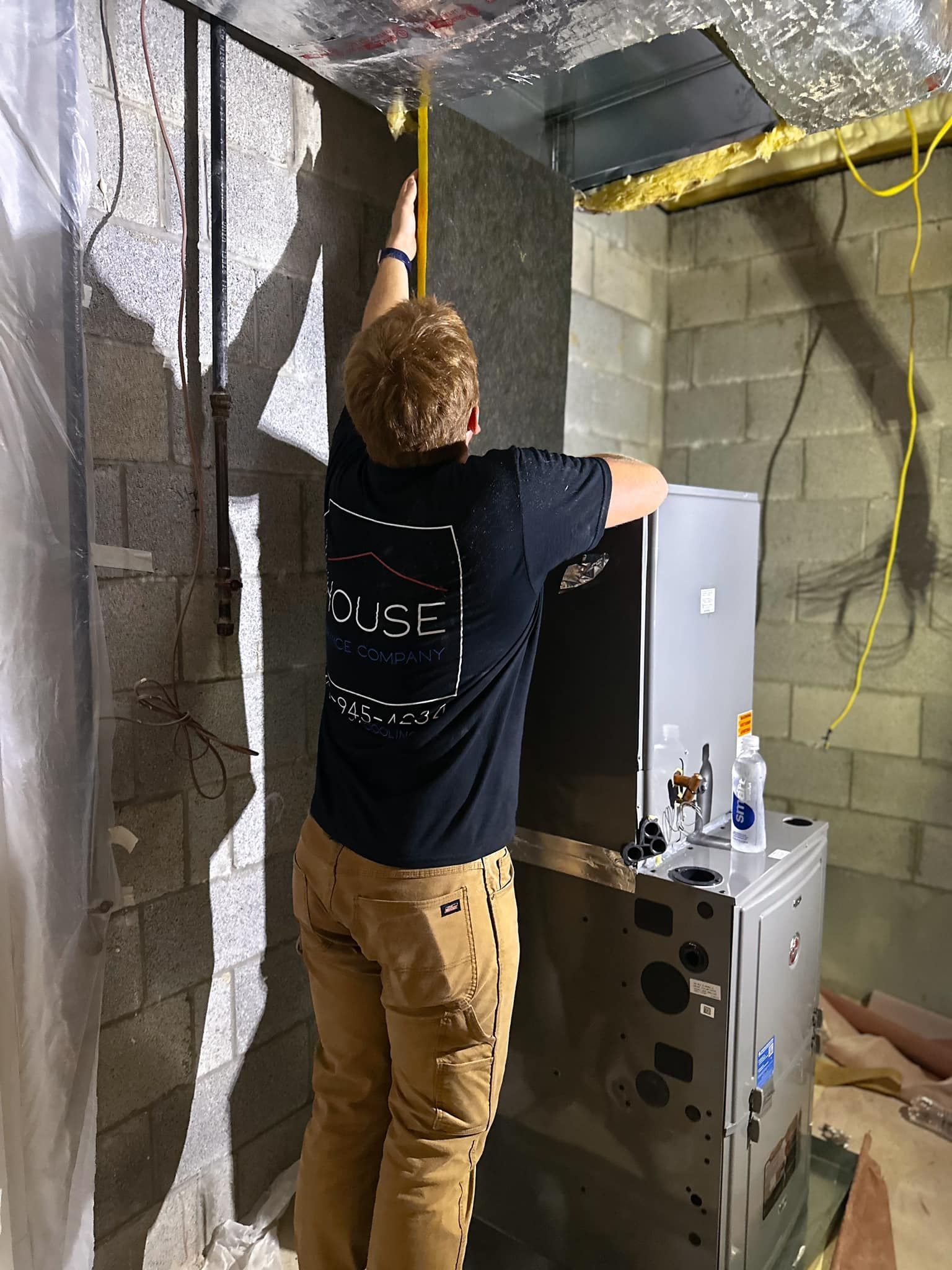 An air conditioner is sitting in the attic of a house under construction