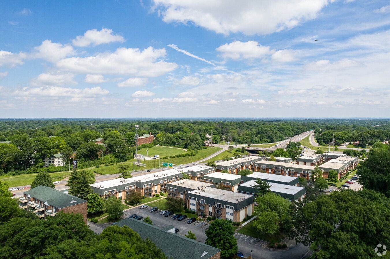 An aerial view of a residential area with lots of trees and buildings.