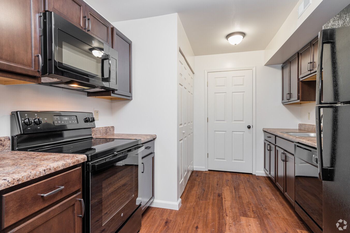 A kitchen with stainless steel appliances and wooden cabinets