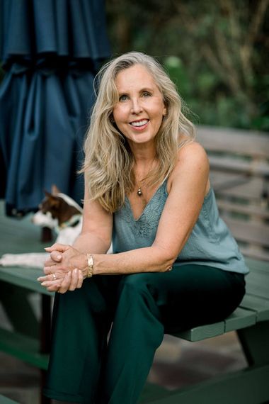 family law attorney annabel wearing green silk pants sitting on a picnic bench