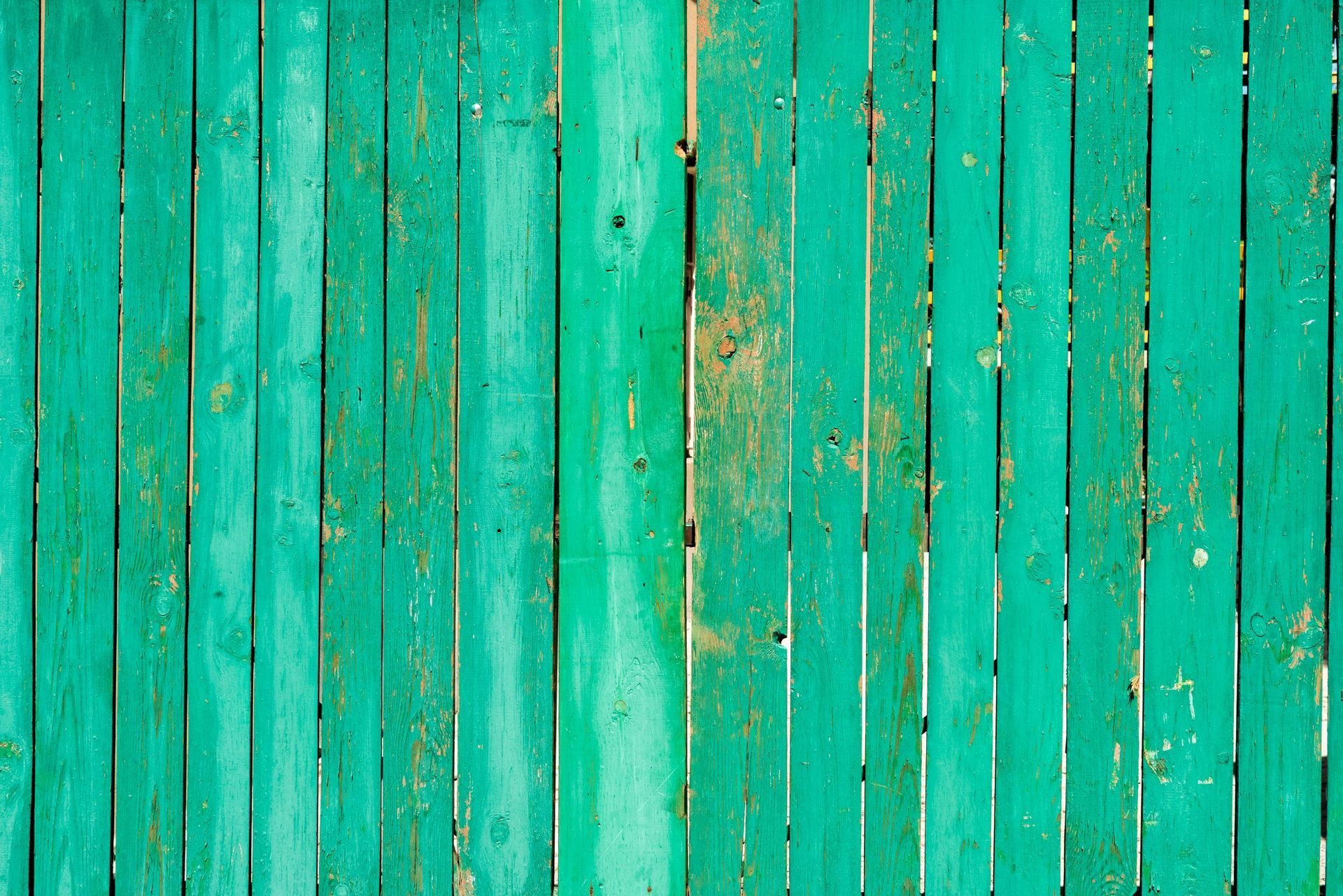 old warped green wooden fence by Superior Fence