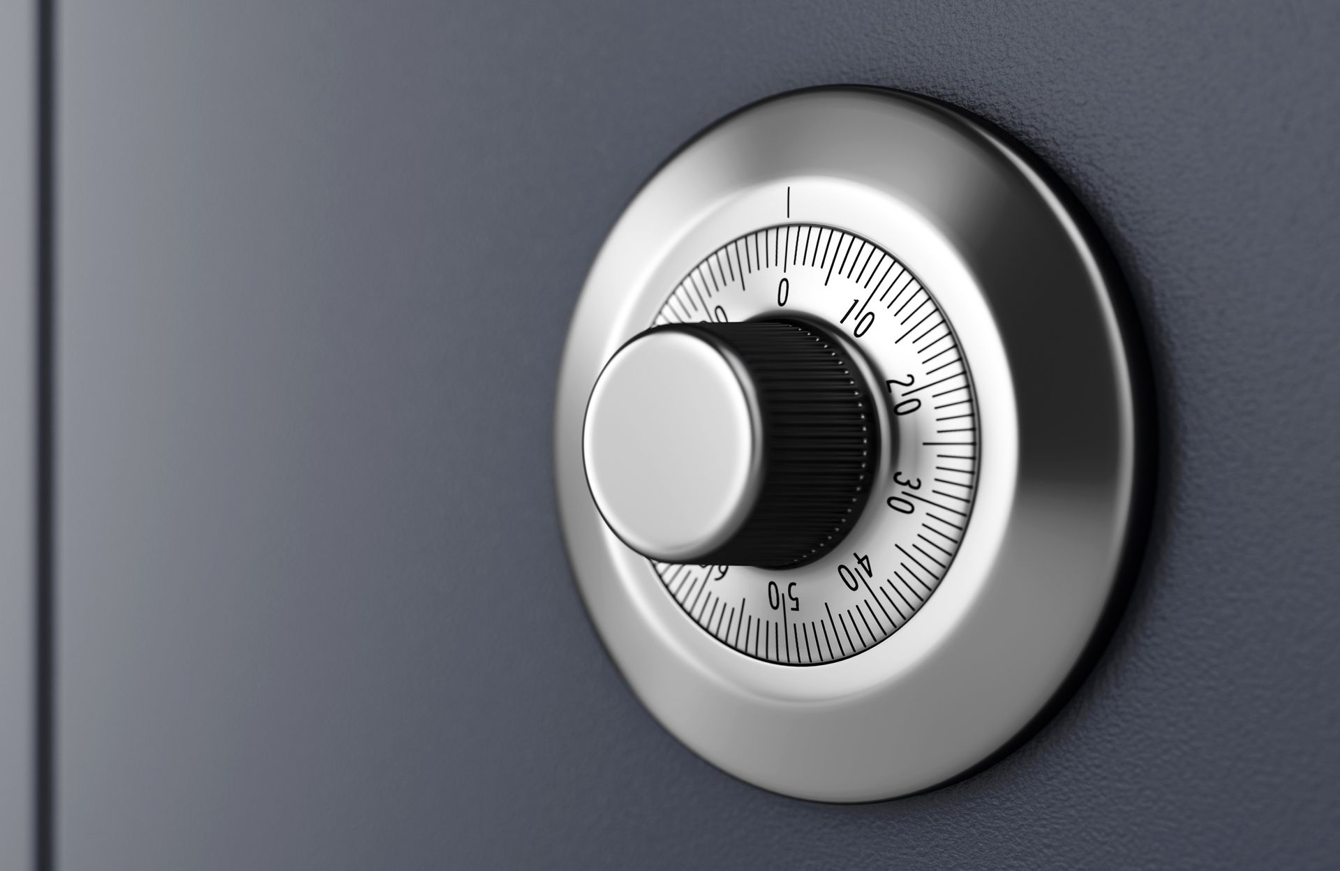 Safe dial, metallic, on a dark gray door. Knob at 10.