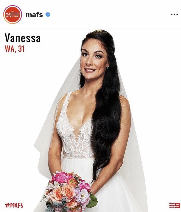 A woman in a wedding dress is holding a bouquet of flowers