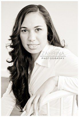 A black and white photo of a woman sitting in a chair.