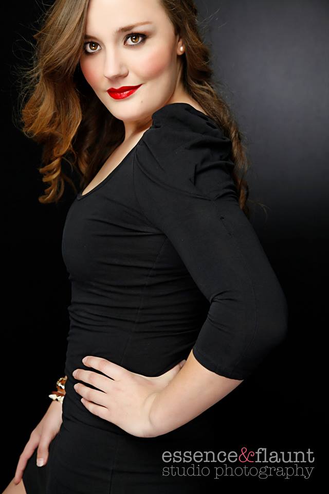 A woman in a black dress with red lipstick by essence flaunt