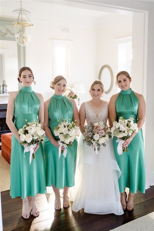 stunning bride and bridesmaids together after having their hair and makeup done by Juliet