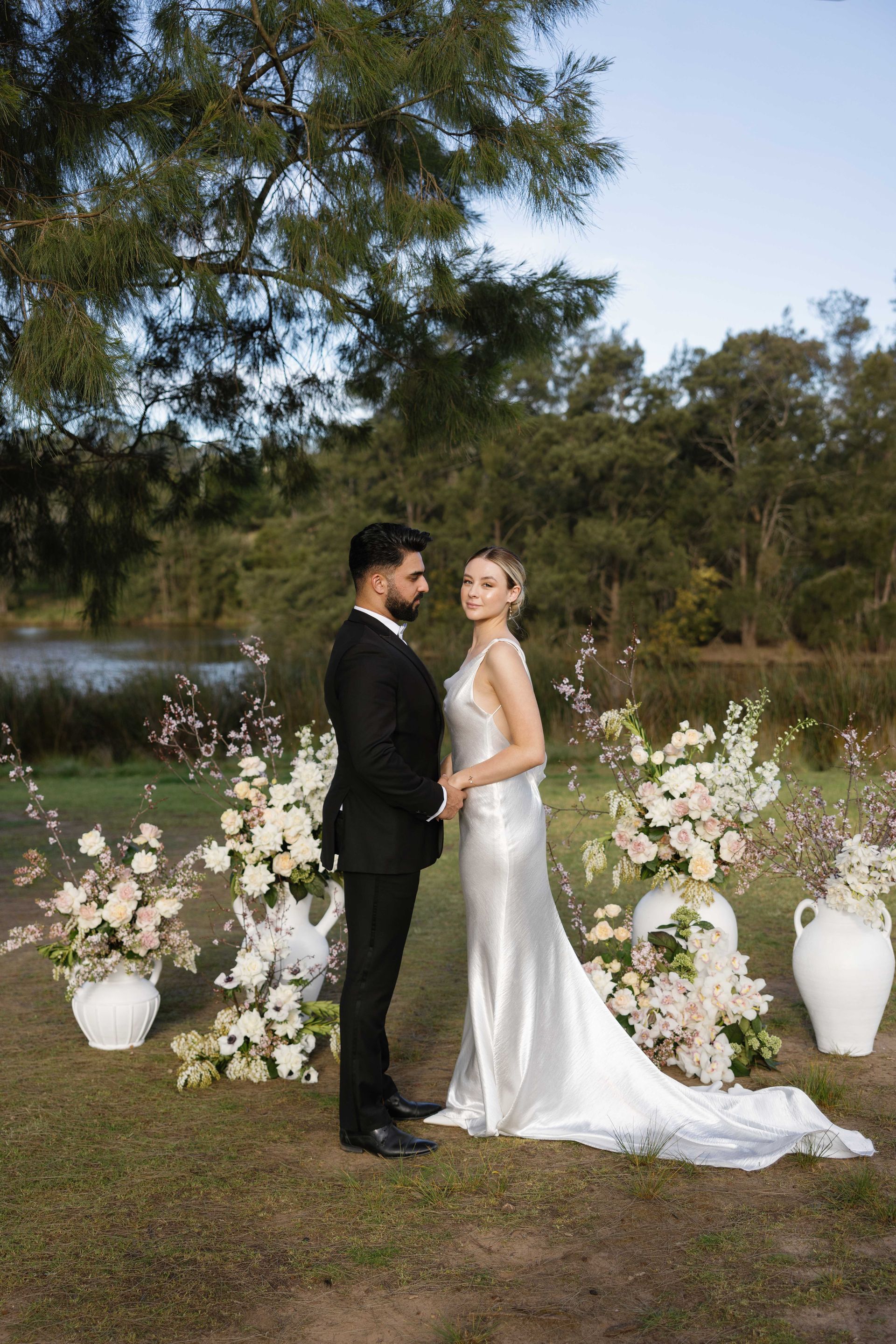 bride and groom with flowers and beautiful hair and makeup by Juliet Lynch