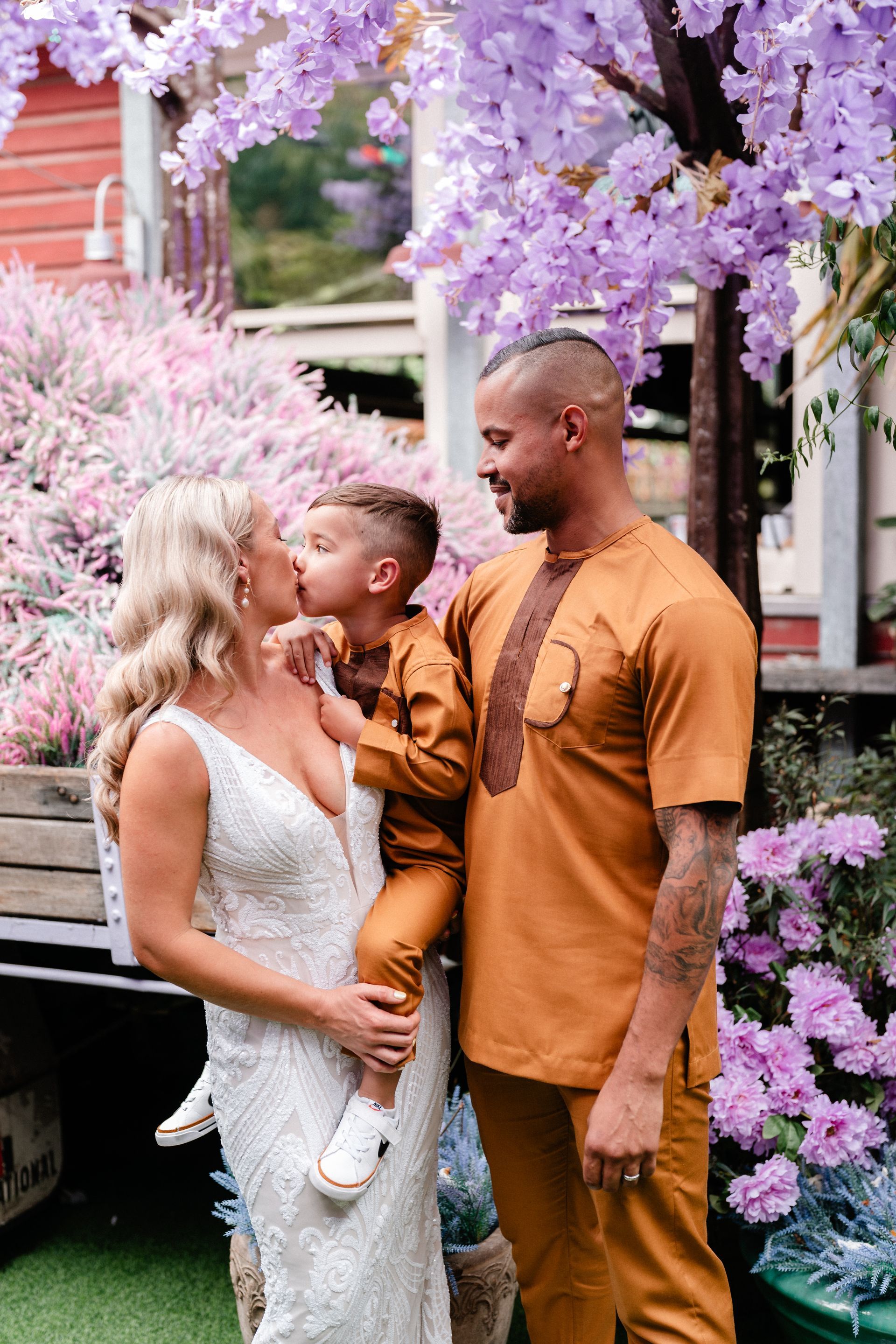 bride and groom with their child. Stunning hair and makeup by Juliet Lynch