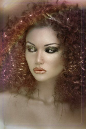 A mannequin with curly hair and makeup is wearing a wig.