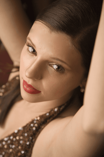 A close up of a woman 's face with red lipstick