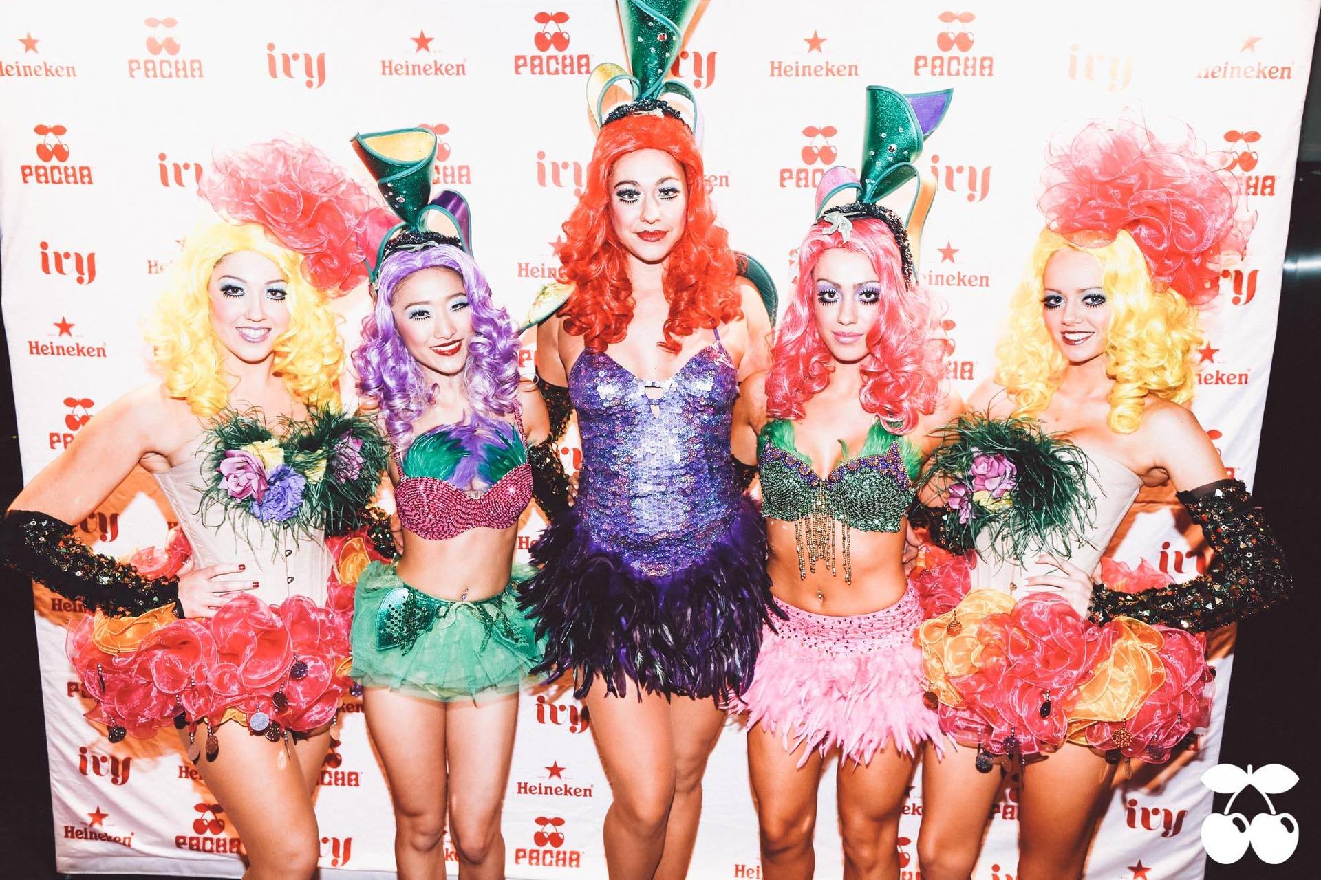 A group of women standing in front of a wall that says try