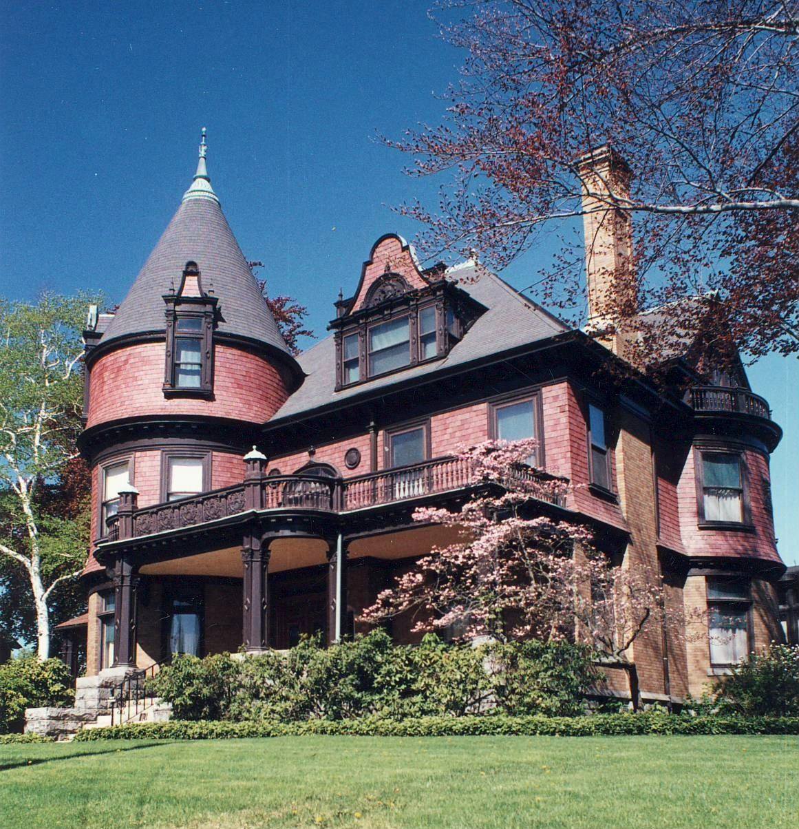A large brick house with a tower on top of it