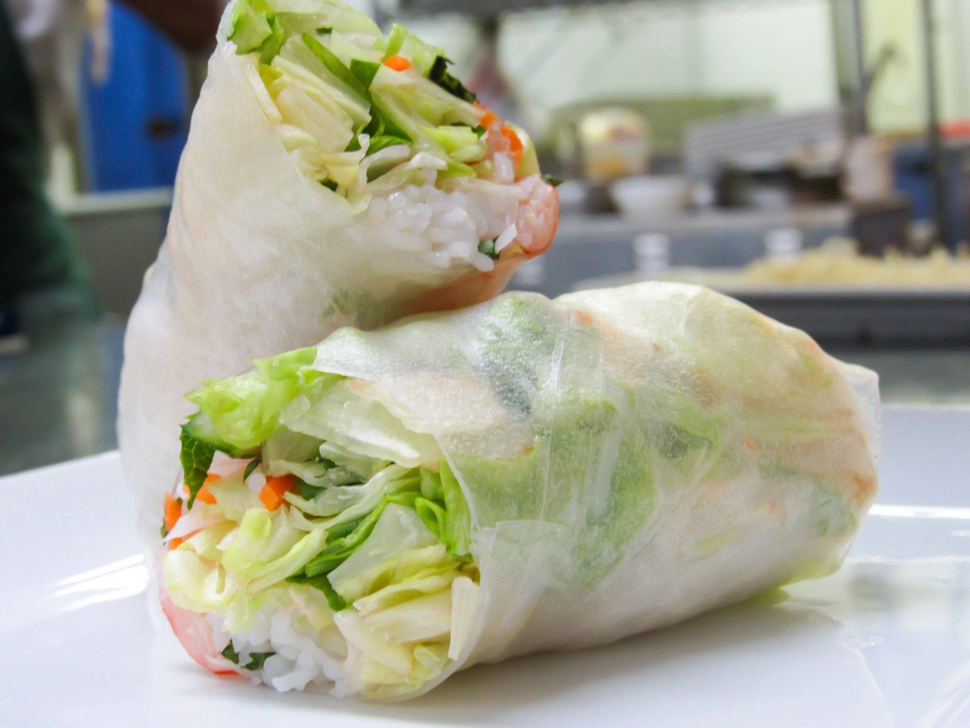 A close up of a vegetable roll on a white plate