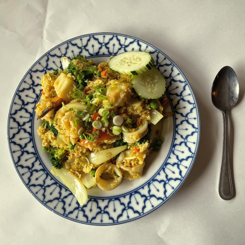 A plate of food with a spoon next to it