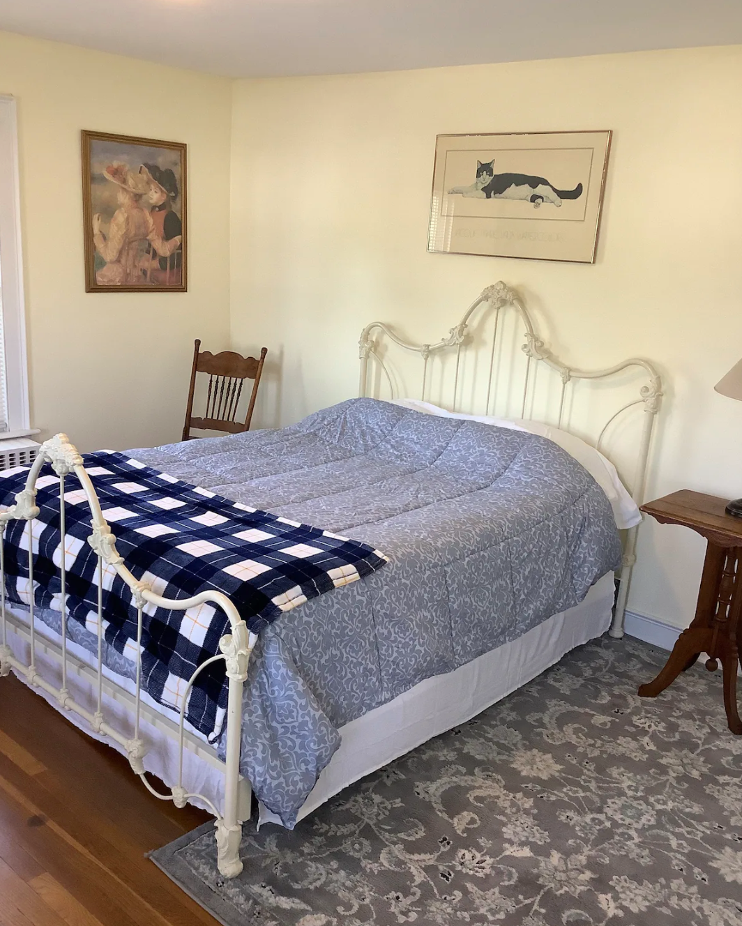 A bedroom with a large bed and a chair