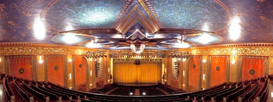 A large auditorium with rows of seats and a stage.