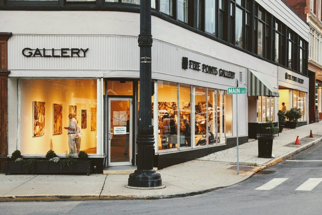 A gallery is located on the corner of a city street