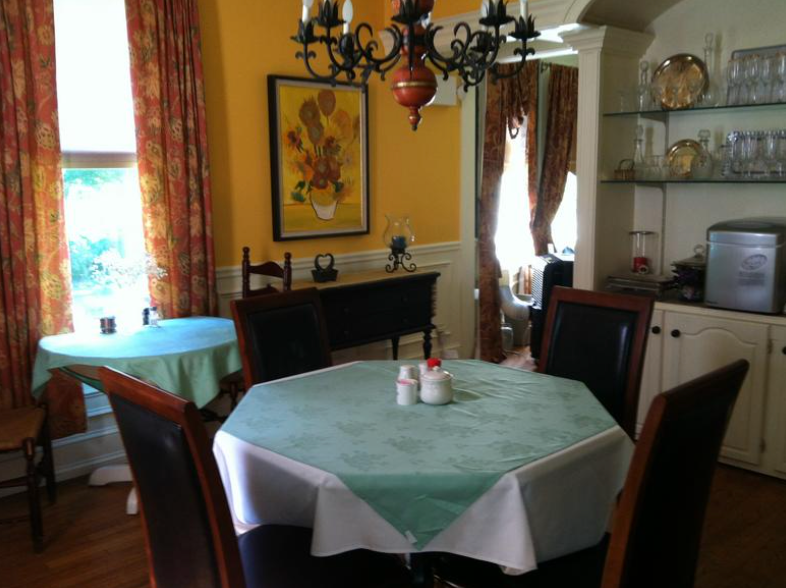 A dining room with tables and chairs and a chandelier