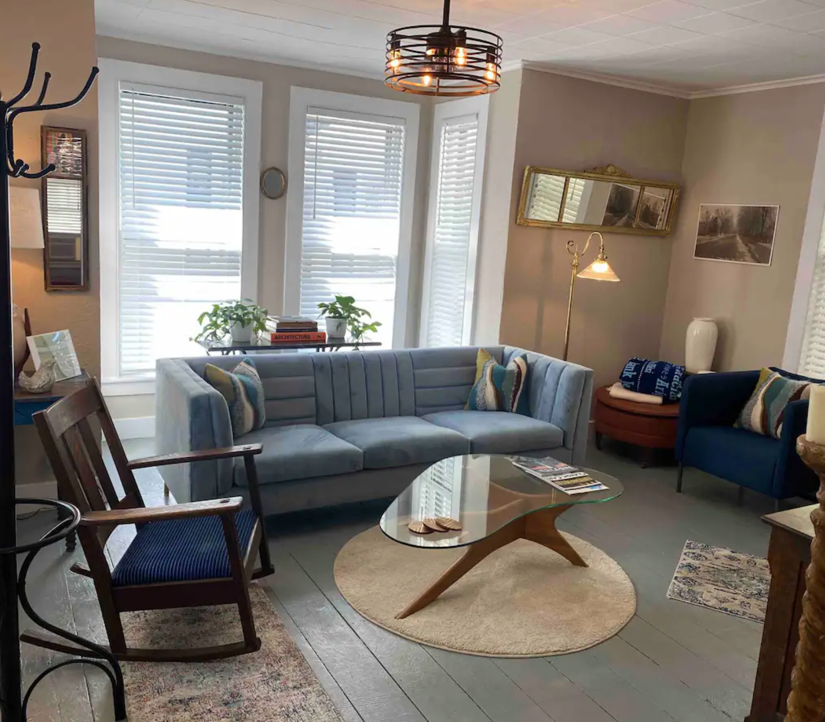 A living room with a couch , chair , and coffee table.