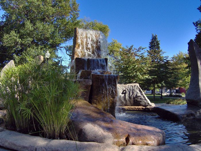 Two little girls wearing sunglasses are swimming in a pool.