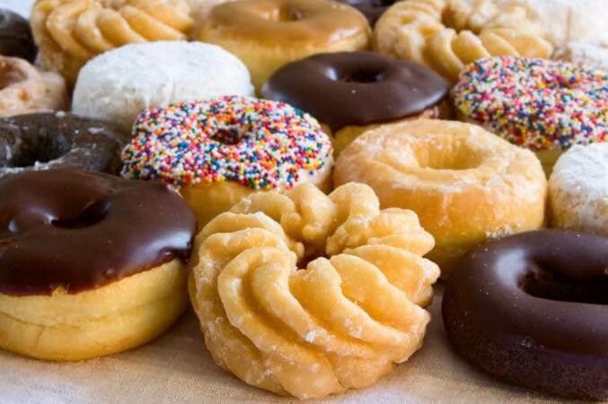 There are many different types of donuts on the table.
