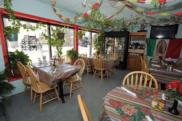 The inside of a restaurant with tables and chairs