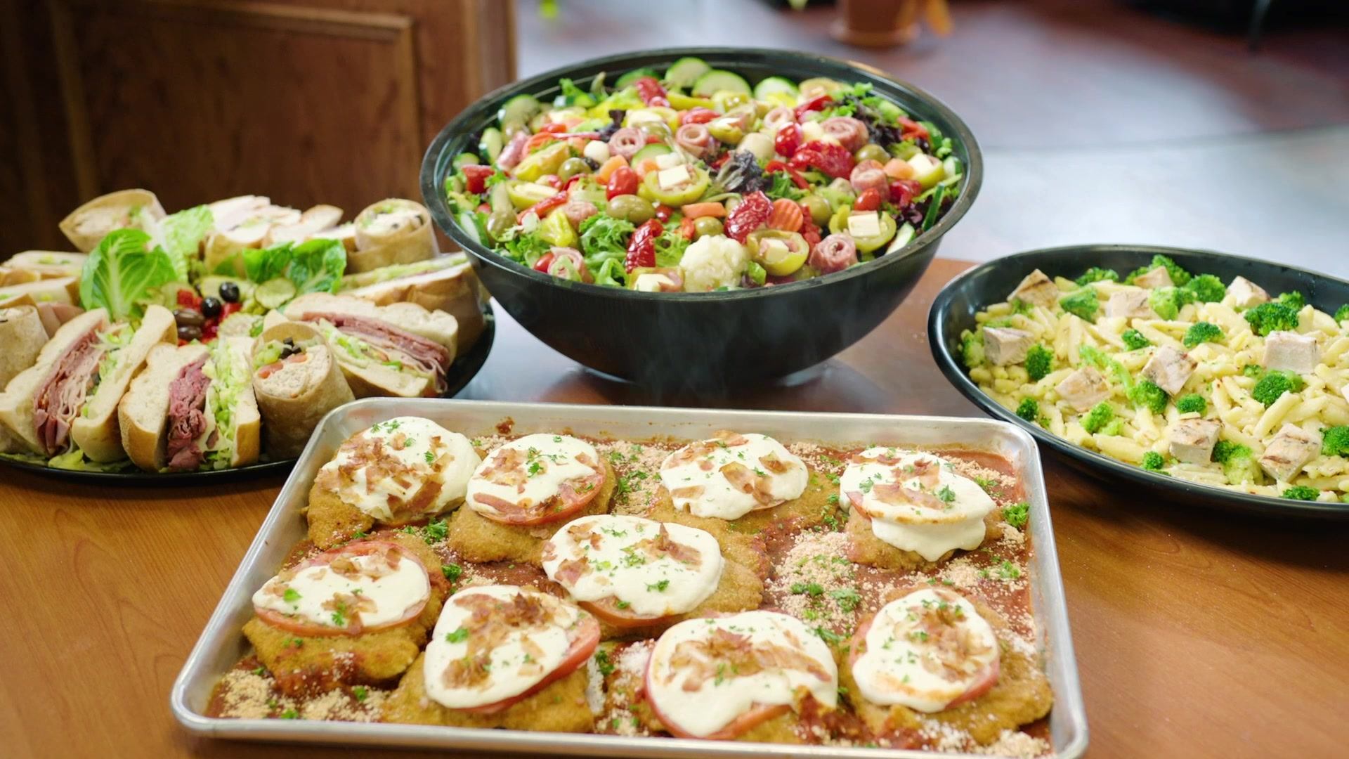 A table topped with plates of food and a bowl of salad.