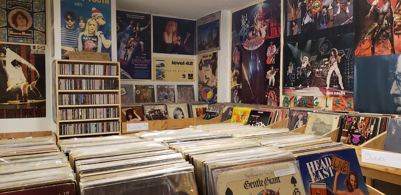 A room filled with lots of records and posters on the walls.