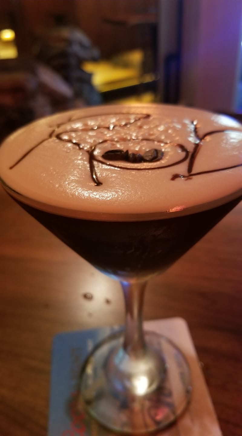A close up of a martini with chocolate on top