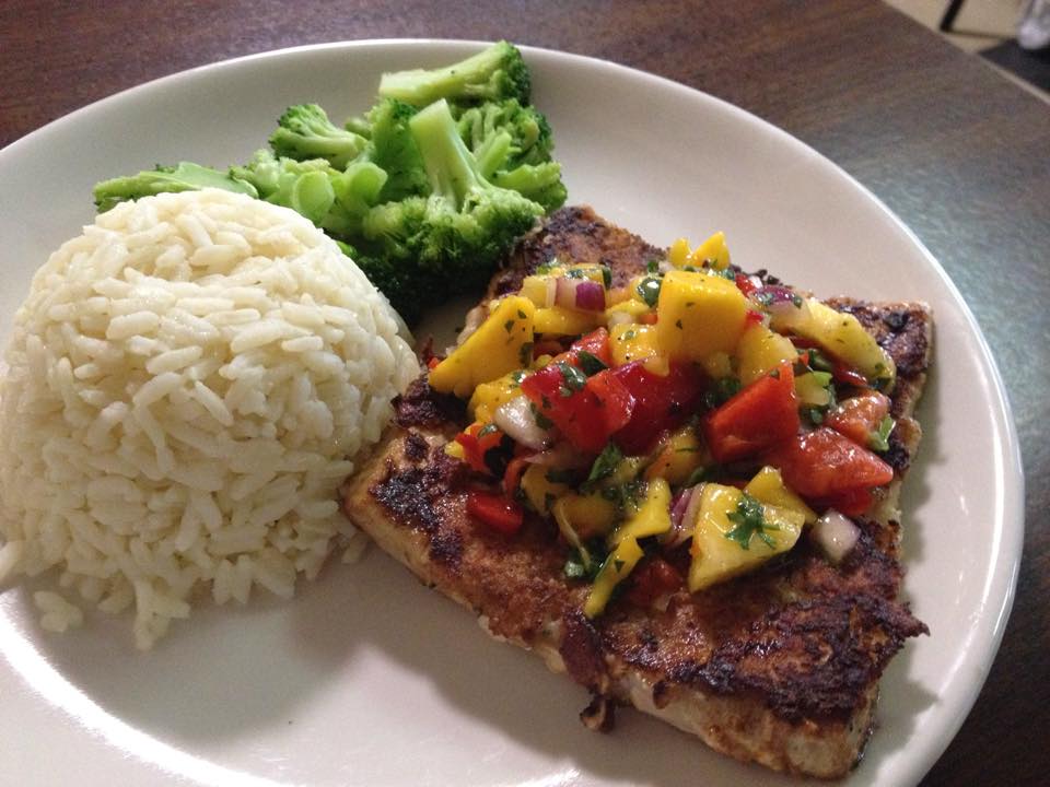 A plate of food with broccoli and rice on a table