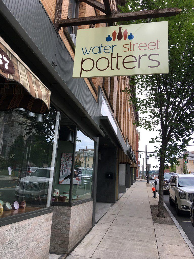 A store front with a sign that says water street potters