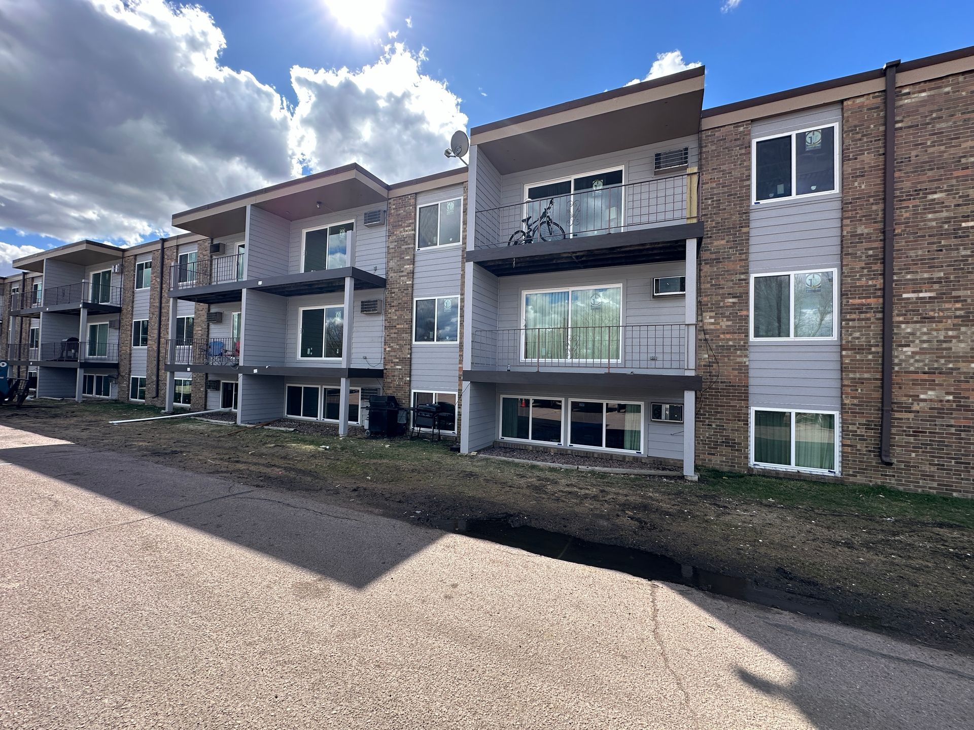 A large apartment building with a lot of windows and balconies.