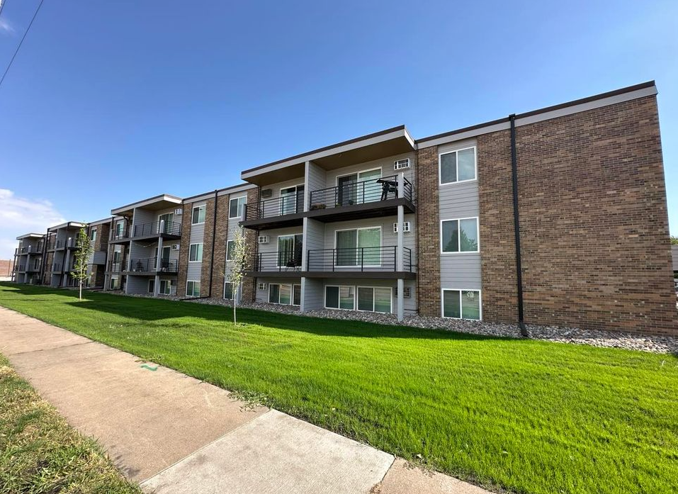 A large apartment building with a lot of windows and balconies.