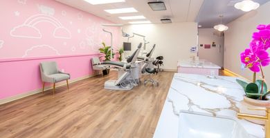 Dentist pointing at a screen explaining 