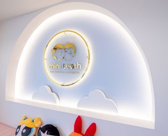 A healthcare professional showing a child colorful mouth guards. The child points to one.