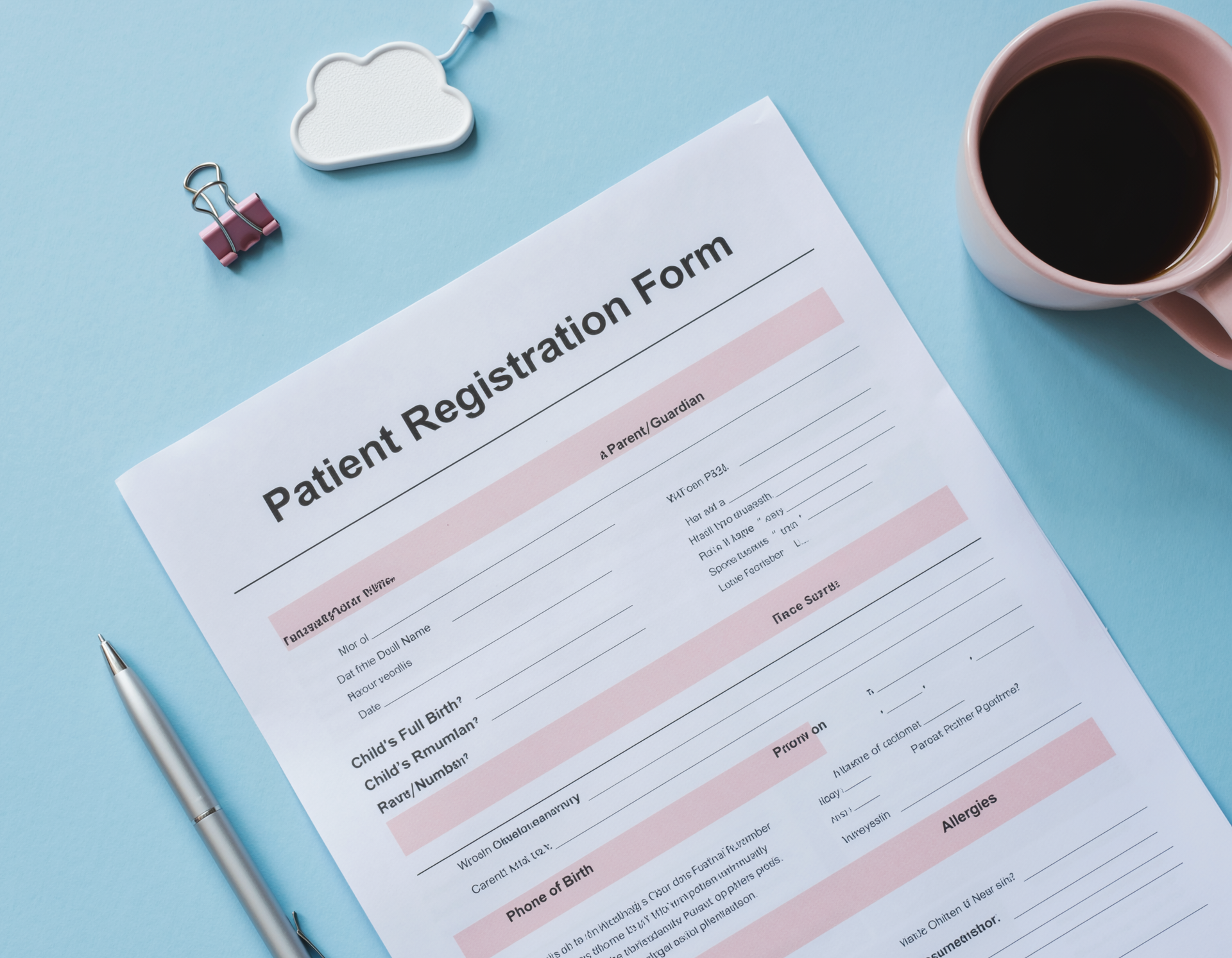 Patient registration form on a blue desk with coffee cup, pen, and small decorative items.