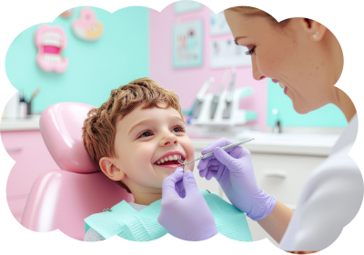 Boy at dentist's appointment, smiling. Dentist examining teeth with instruments, pink and teal room.