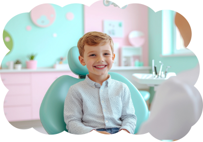 Boy smiling in a dental chair in a colorful dentist's office.