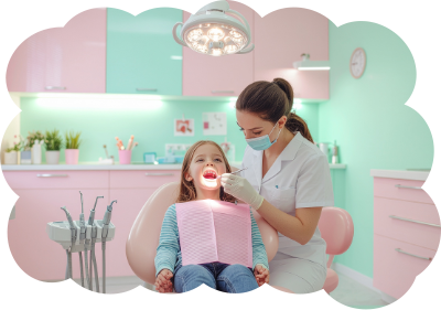 Dentist examining a child's teeth in a pink and mint-colored office.