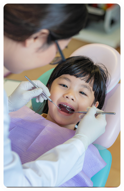 Child smiling at the dentist during a check-up