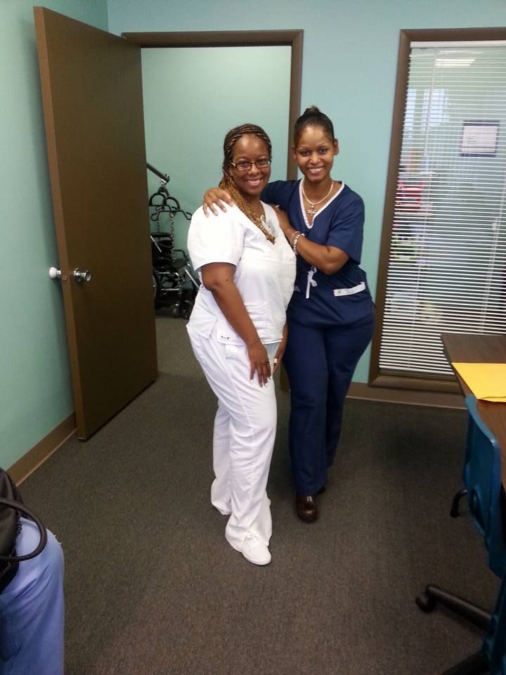 Two Nurses Posing for a Picture in a Room