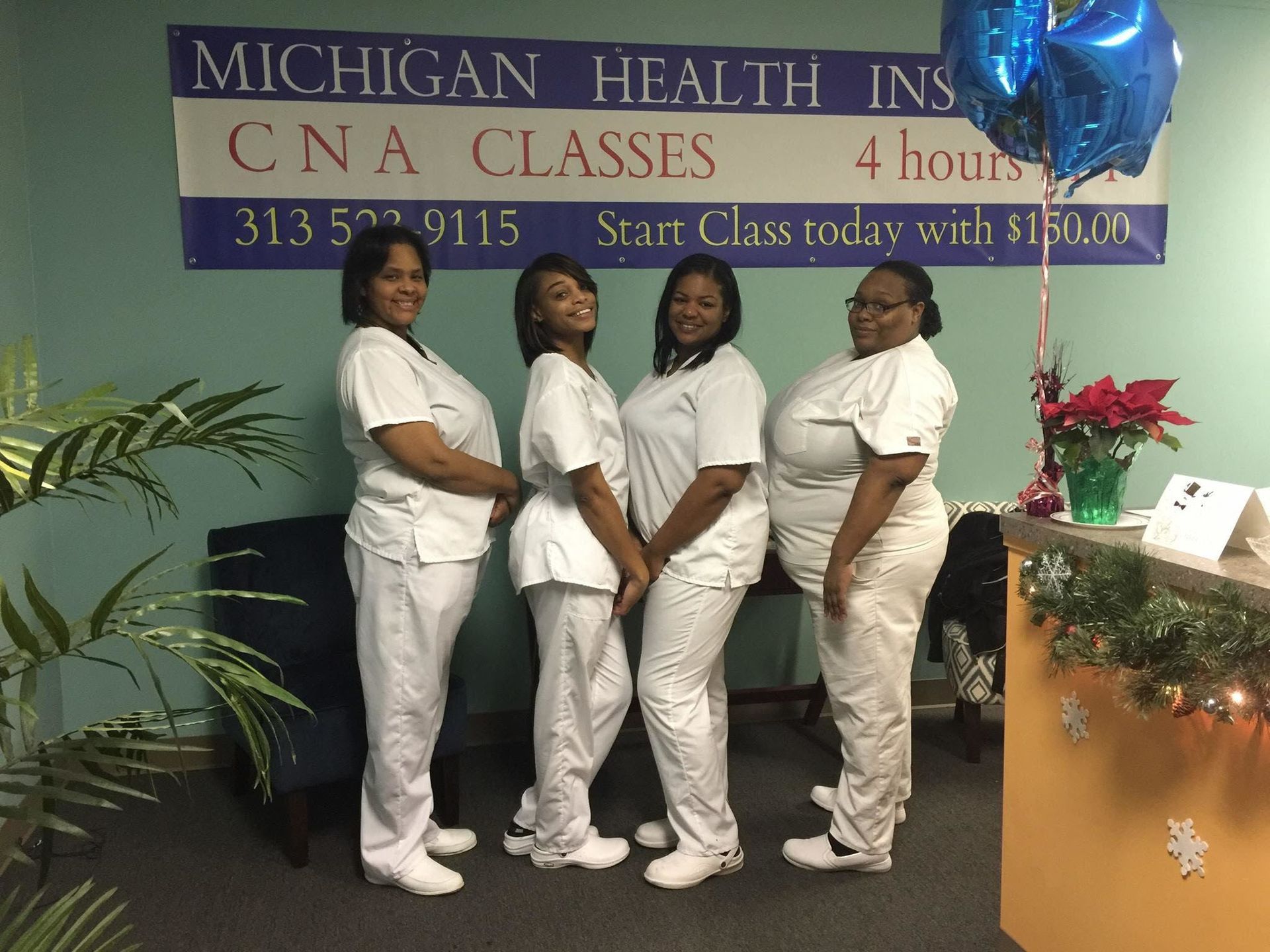 A Group of Women Standing in Front of a Sign That Says Michigan Health Ins Cna Classes
